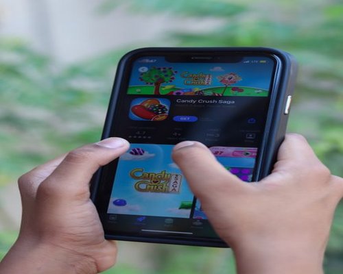 Main smartphone showing the fictional Crown Pixel Velocity speed game